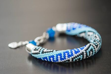 Bead Crochet Bracelet with ornament on a dark backgroundの写真素材