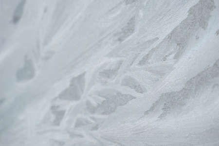 Frozen window glass with frost patternsの写真素材