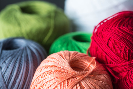 Several skeins of yarn in different colors close up