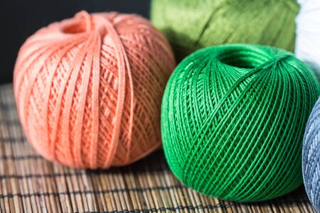 Several skeins of yarn in different colors close up