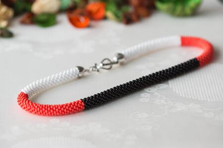 Crochet beaded necklace of red, white and black colorの写真素材