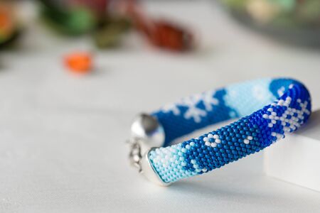 Handmade beaded bracelet with the image of snowflakesの写真素材