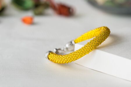 Handmade yellow bracelet made of small beadsの写真素材