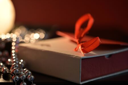 Burning candle, gift box and Christmas decorationsの写真素材
