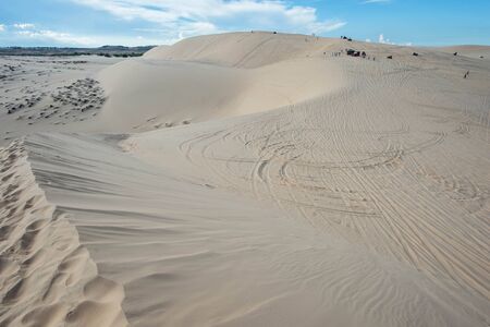 Blue cloudy sky over sand dunes in the eveningの写真素材