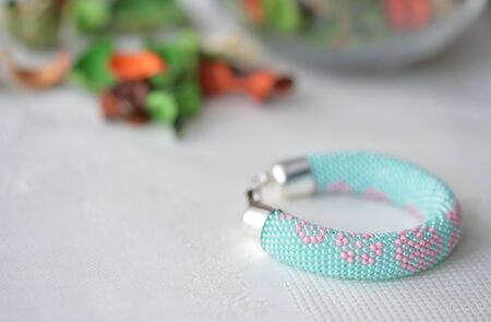 Handmade beaded bracelet with floral print close upの写真素材