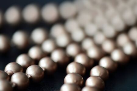 Long necklace made of brown beads on a dark backgroundの写真素材