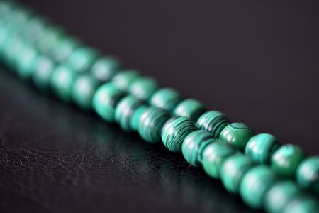 Green malachite necklace on a dark background closeupの写真素材