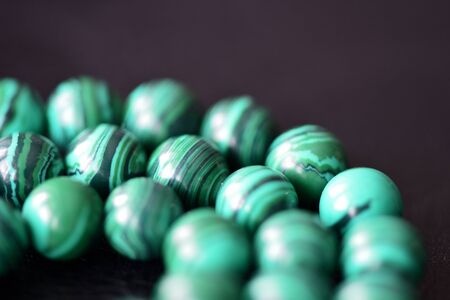 Green malachite necklace on a dark background closeupの写真素材