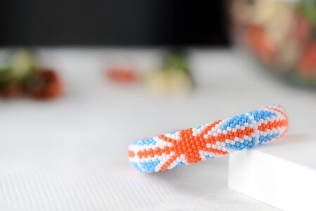 Handmade beaded bracelet with United Kingdom flag close upの写真素材