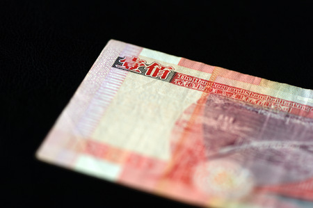 100 Hong Kong dollars on a dark background close up