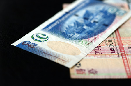 Some banknotes of Hong Kong dollars on a dark backgroundの写真素材