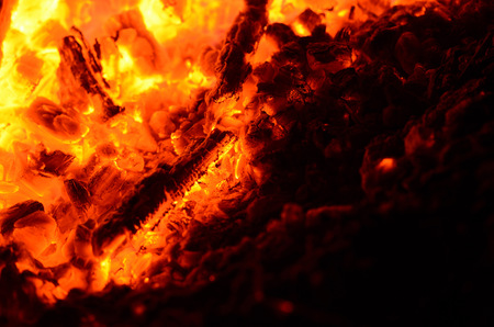 Flames and sparks of a burning fire as the backgroundの写真素材