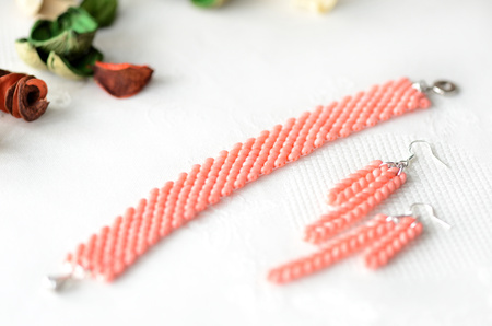 Beaded bracelet and earrings light coral color close upの写真素材