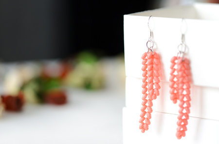 Handmade beaded earrings coral color close upの写真素材
