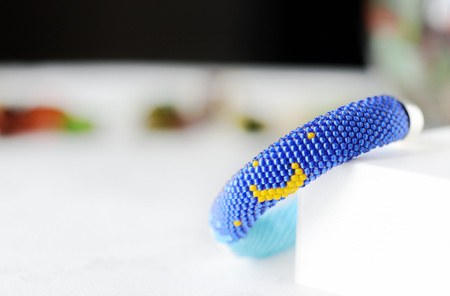 Beaded bracelet with white cat and yellow moonの写真素材