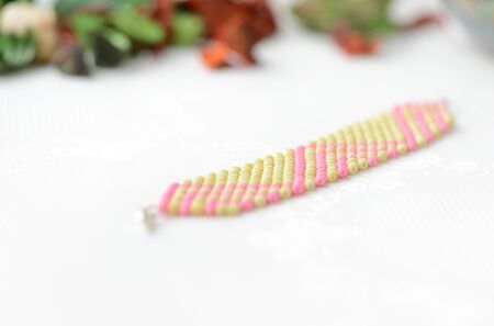 Wide beaded bracelet light green and pink color close up