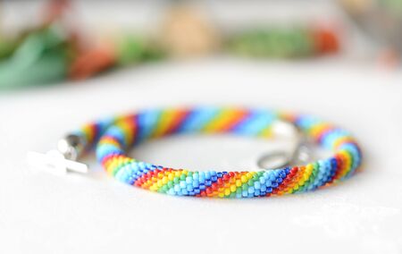Rainbow beaded necklace on a textile background close upの写真素材