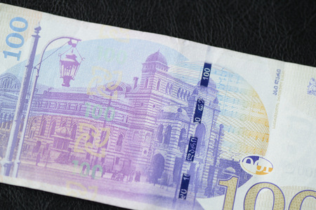 Georgian banknote in one hundred lari on a dark background close up