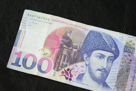 Georgian banknote in one hundred lari on a dark background close upの写真素材