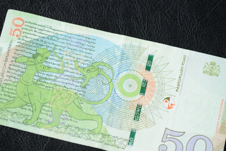 Georgian banknote in fifty lari on a dark background close up