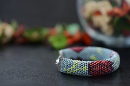 Bead crochet bracelet gray color with flower print close upの写真素材