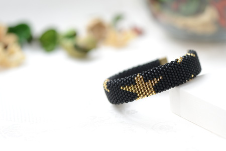 Black beaded bracelet with golden stars close upの写真素材