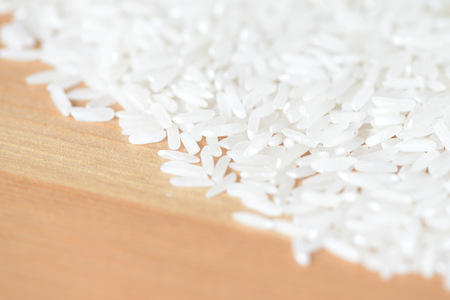 Scattered rice grains on the wooden surfaceの写真素材