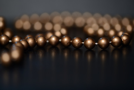 Long brown necklace on a dark background