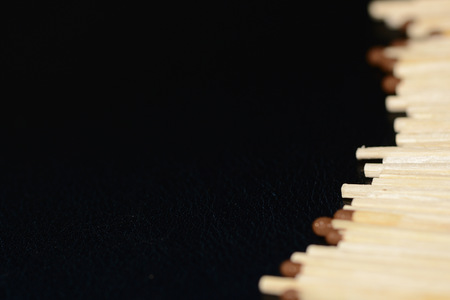 Scattered matches on dark background close upの写真素材