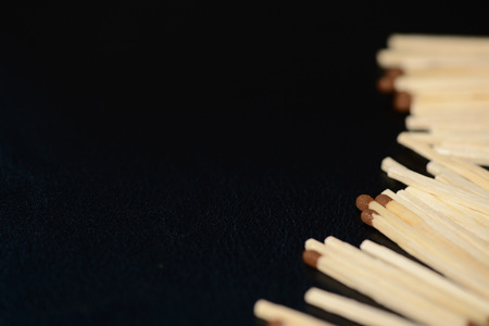 Scattered matches on dark background close upの写真素材