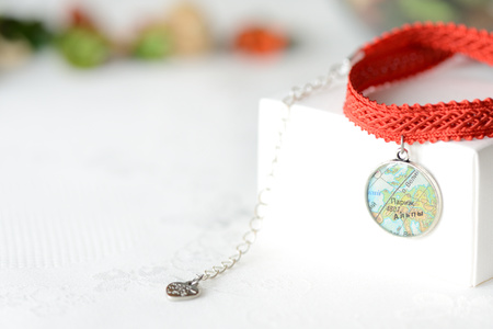 Red choker with a map pendant close upの写真素材