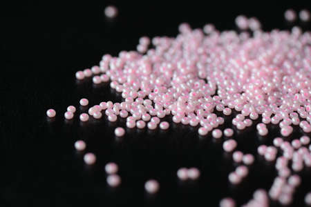 Pink seed beads on a dark background close upの写真素材