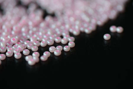Pink seed beads on a dark background close upの写真素材