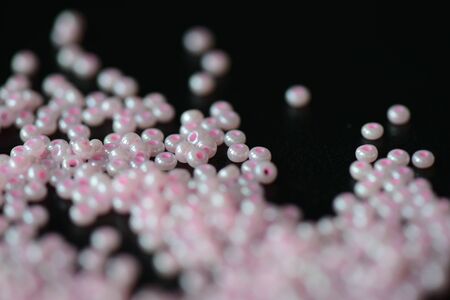 Pink seed beads on a dark background close upの写真素材