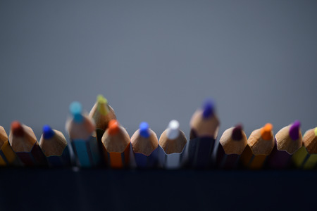 A pack of multicolored pencils on a dark gray background close upの写真素材