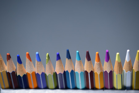 A pack of multicolored pencils on a dark gray background close upの写真素材