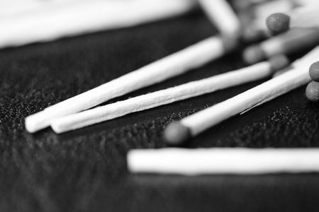 Scattered matches on dark background close up. Black and whiteの写真素材