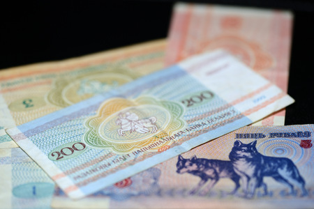 Obsolete Belarusian banknotes on a dark background close up
