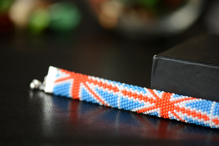 Beaded bracelet British flag on a dark background close upの写真素材