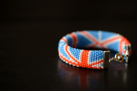 Beaded bracelet British flag on a dark background close upの写真素材