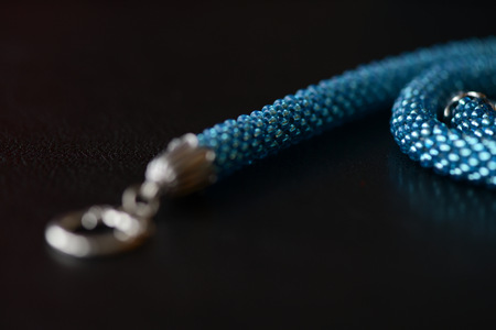 Beaded necklace of turquoise color on a dark background close upの写真素材