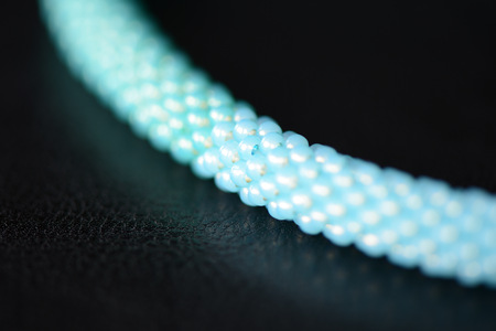 Seed bead necklace aquamarine color on a dark background close upの写真素材