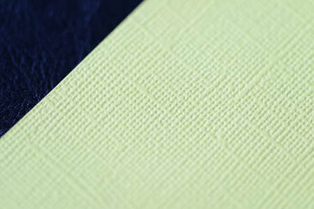 Colorful cardboads on a dark leather background close up