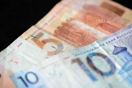 Two Belarusian banknotes on a dark background close up