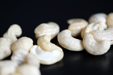 Cashew nuts on a dark background close upの写真素材