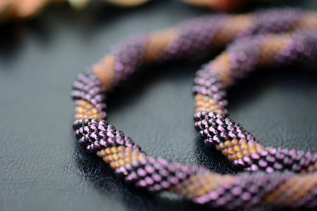 Spiral beaded necklace two colors on a dark background close upの写真素材