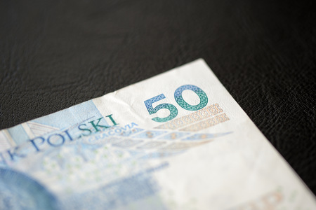 Fifty Polish zlotys on a dark background close up