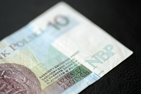 A banknote in ten Polish zlotys against a dark background close upの写真素材