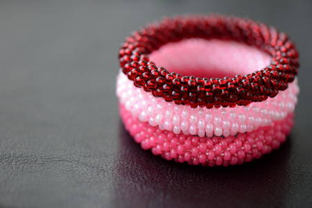 Set of three beaded children's bracelets on a dark background close upの写真素材